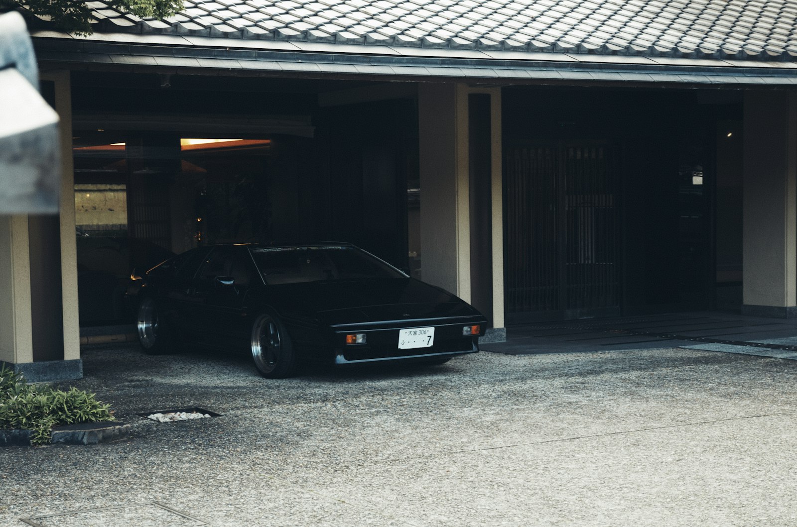 A car parked under a residential metal carport