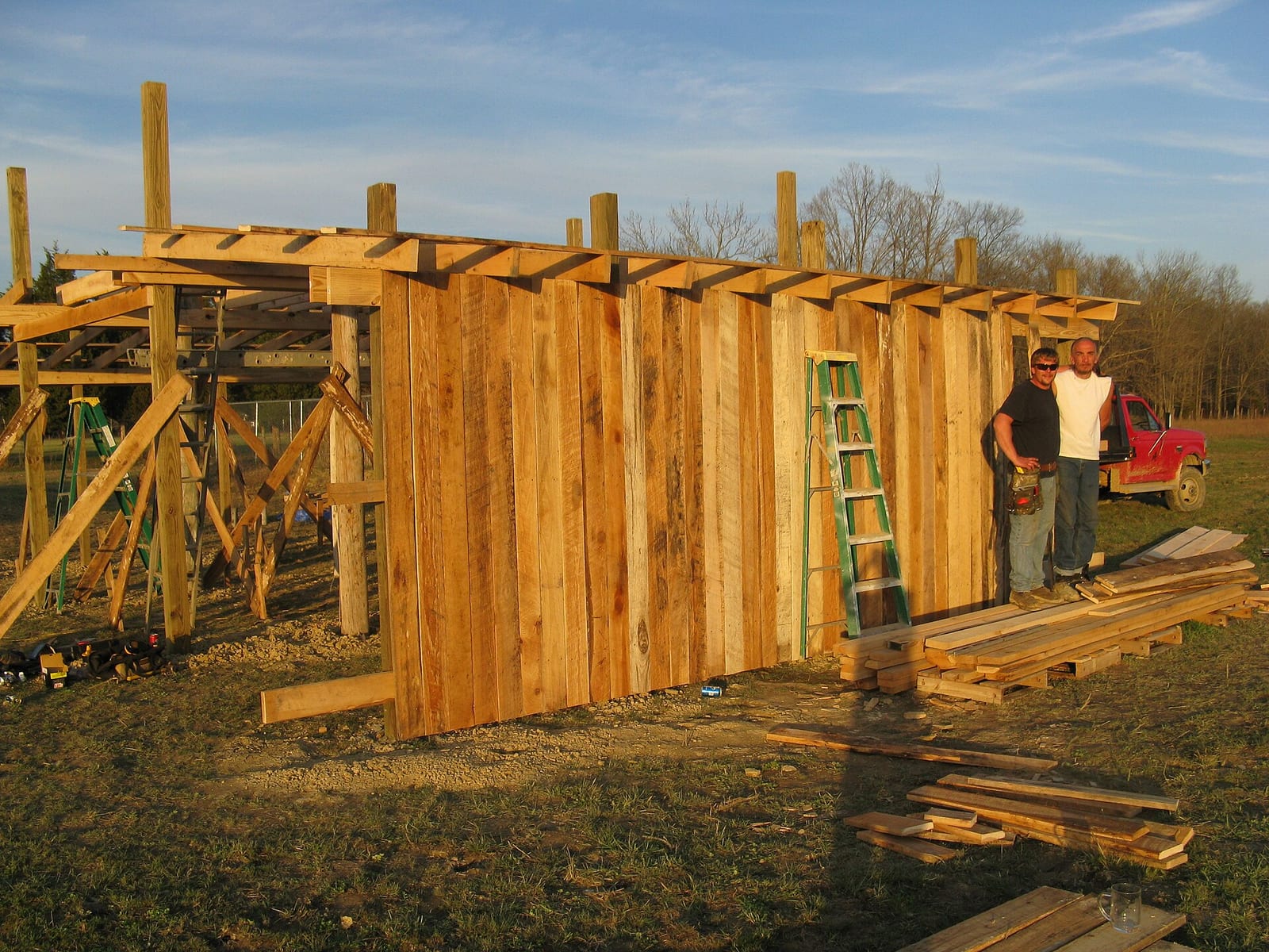 A pole barn under construction showing the post-frame skeleton