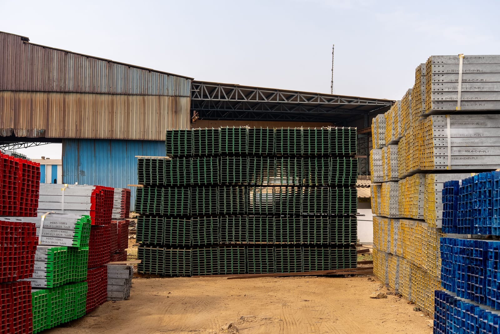 Stacked steel building materials and framing components on a construction site