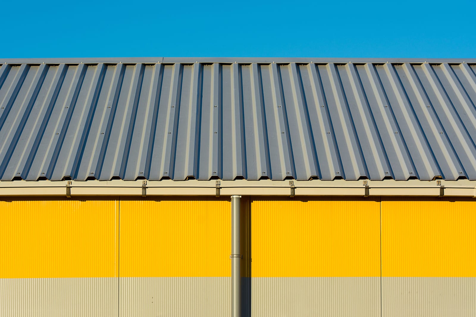Corrugated metal siding panel on the exterior wall of a warehouse building