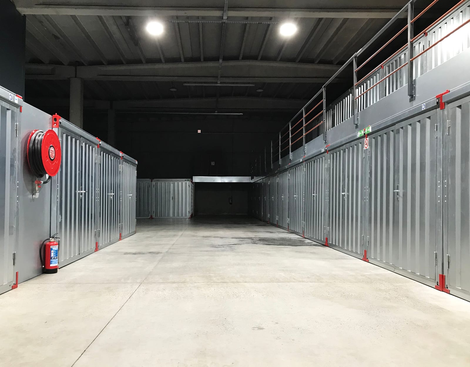 An interior corridor in a storage facility with steel units on either side