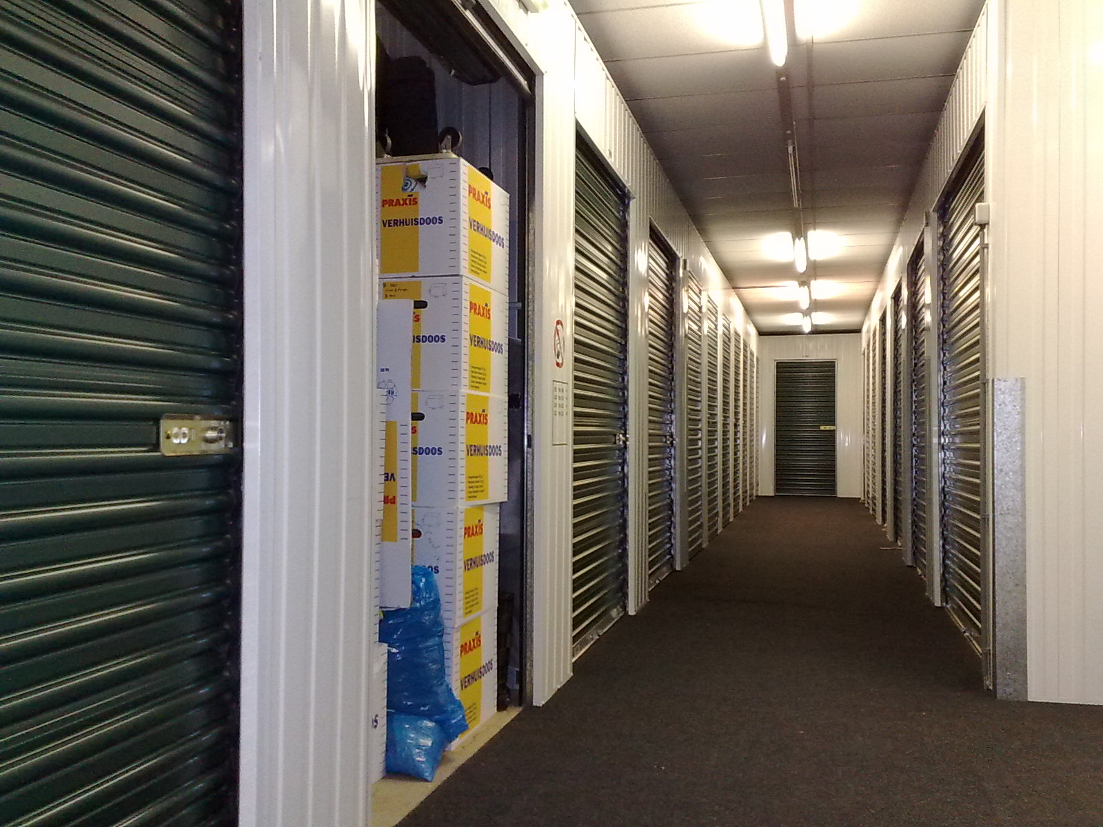 A corridor lined with self-storage units in a climate-controlled facility